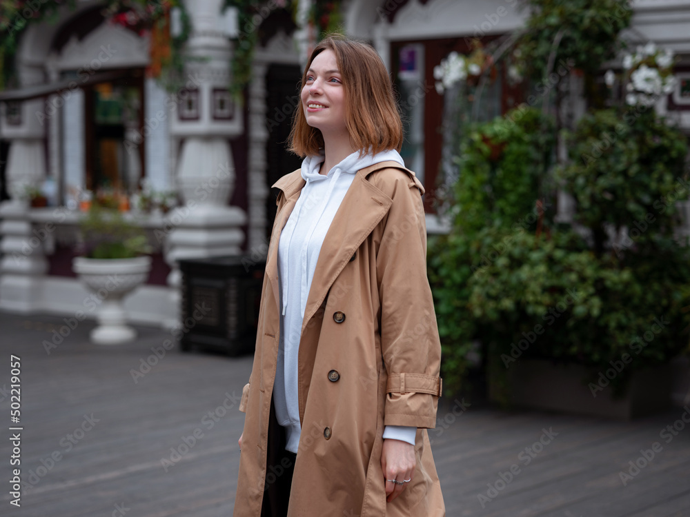 Beautiful woman walk in autumn cloudy Moscow. Street style. Travel to Russia concept.