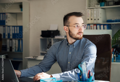 Businessman working on his laptop in an office