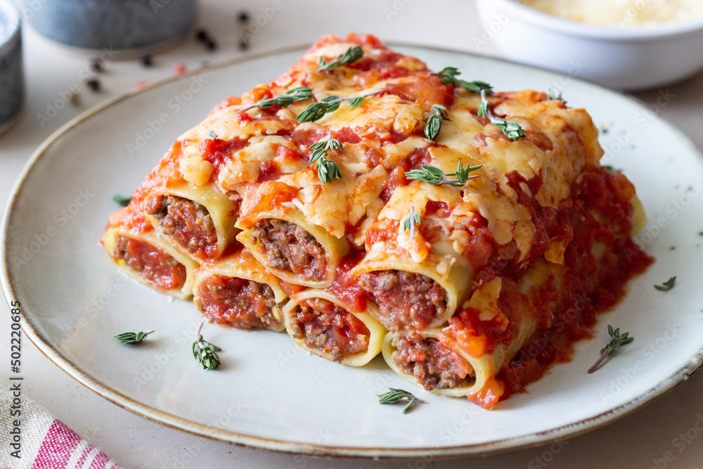 Cannelloni with meat, cheese, tomatoes and thyme. Italian cuisine. Cannelloni with meat, cheese, tomatoes and thyme. Italian cuisine.