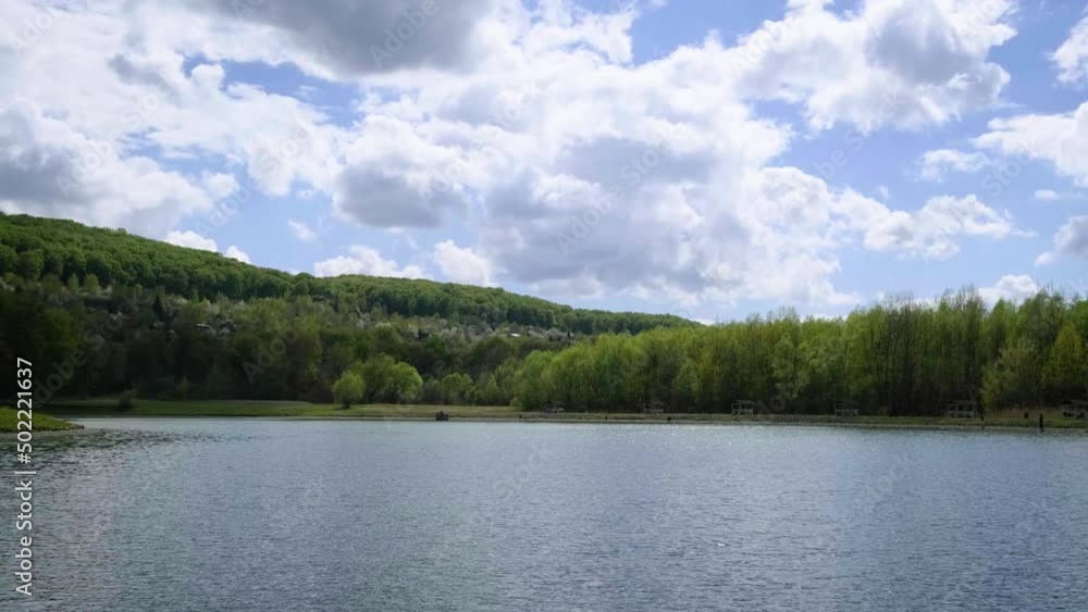 Lake, sky, forest. Blue water in a forest lake with pine trees. River and lakes with reflections in the morning and evening. Lake in beautiful summer day. Silent lakes near green forest Lake, sky, forest. Blue water in a forest lake with pine trees. River and lakes with reflections in the morning and evening. Lake in beautiful summer day. Silent lakes near green forest