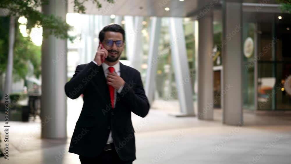 Young businessman wearing suit walking on street in city Young businessman wearing suit walking on street in city