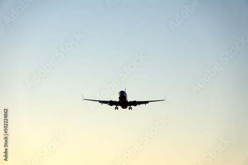 Commercial jet flying  in silhouette  in the evening  in Fort Lauderdale  Florida  USA