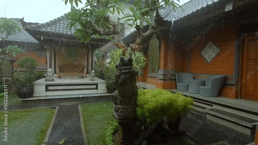 Small porch and seating area in a traditional Balinese courtyard on a rainy day Small porch and seating area in a traditional Balinese courtyard on a rainy day