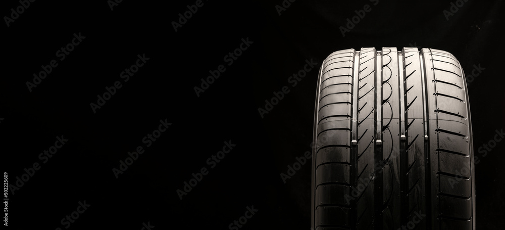 new summer tire on a black background, copy space new summer tire on a black background, copy space