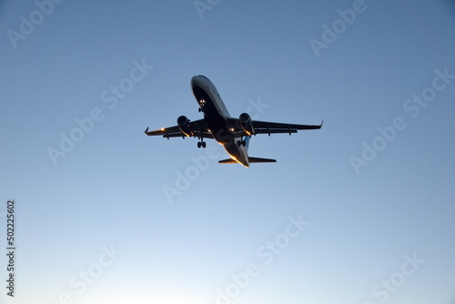 Fototapeta Naklejka Na Ścianę i Meble -  Commercial jet flying, in silhouette, in the evening, in Fort Lauderdale, Florida, USA