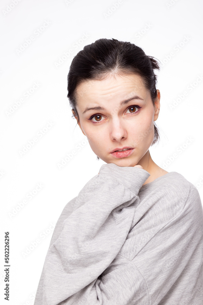 emotional woman in a gray sweatshirt, white background emotional woman in a gray sweatshirt, white background