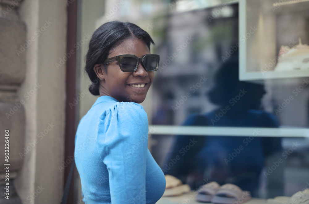 young woman in front of a shop window young woman in front of a shop window