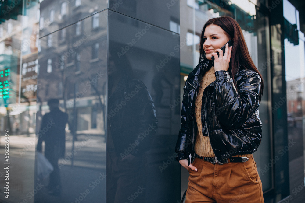 Fototapeta premium Young woman using phone outdoors