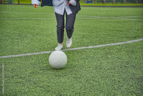 female soccer player kicking the ball in the stadium. photo