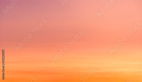 Sunset sky with orange, yellow, pink and purple sunlight in the evening on romantic golden hour clouds background © Nature Peaceful 