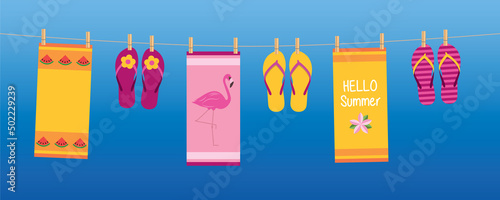 happy summer holiday banner with colorful hanging towels and flip flops