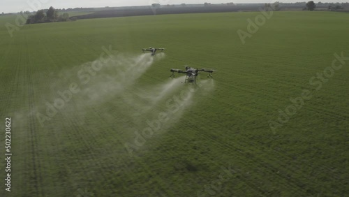 Agro drone works on the field. Field treatment with chemicals. Spraying pesticides against pests. Innovations in the agricultural sector. New technologies. Aerial. 