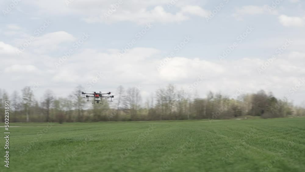 Agro drone works on the field. Field treatment with chemicals. Spraying pesticides against pests. Innovations in the agricultural sector. New technologies. Aerial. Agro drone works on the field. Field treatment with chemicals. Spraying pesticides against pests. Innovations in the agricultural sector. New technologies. Aerial.