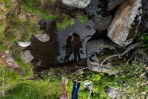 Silhouette of young couple of man and girl against sky in nature