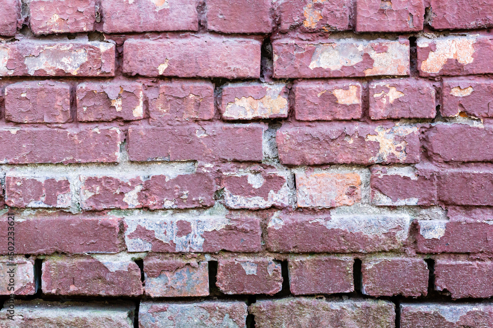 Obraz premium Background of old vintage dirty brick wall with peeling plaster and paint