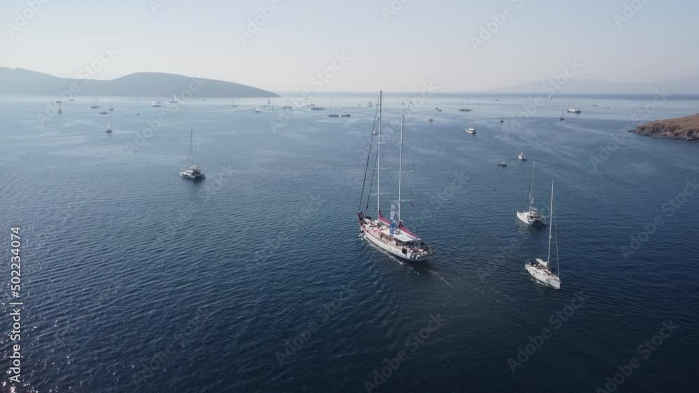 Aerial view of a white yacht crossing Bodrum Harbor, Turkey Aerial view of a white yacht crossing Bodrum Harbor, Turkey