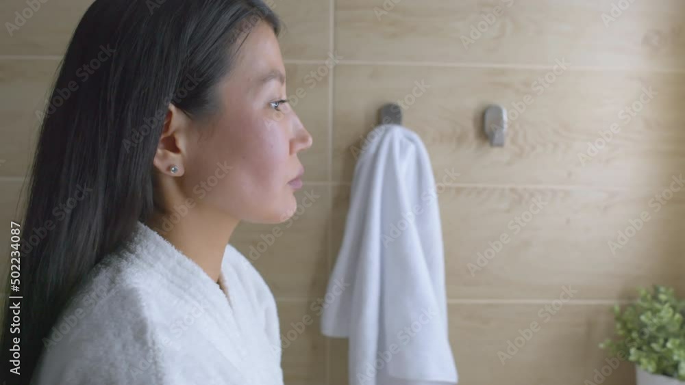 Beautiful woman applying face cream in bath room Beautiful woman applying face cream in bath room