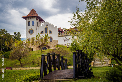 Purcari, Moldova 27.04.2022. Modern winery Chateau Purcari in Purcari village, Moldova, on a clody spring day, Greenery, wooden bridge, lake, logo, white swan, belvedere, vineyard