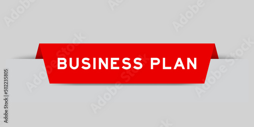 Red color inserted label with word business plan on gray background