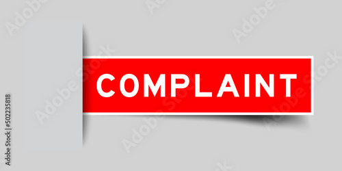 Inserted red color label sticker with word complaint on gray background