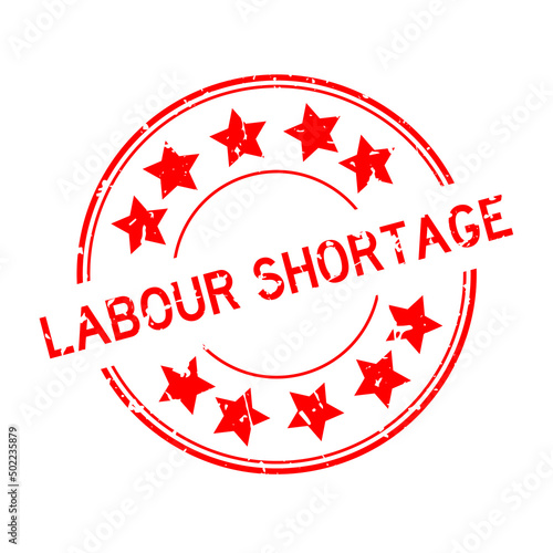Grunge red labour shortage word with star icon round rubber seal stamp on white background