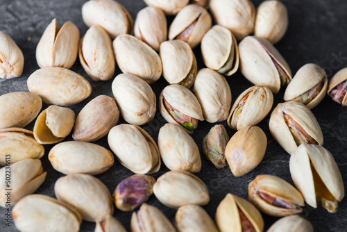 Tasty pistachio nuts on dark  background