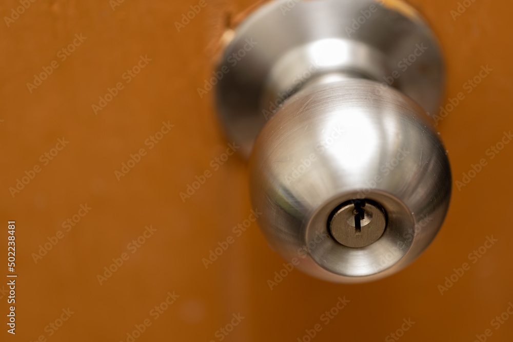 Detail of a metallic knob on wooden door Detail of a metallic knob on wooden door