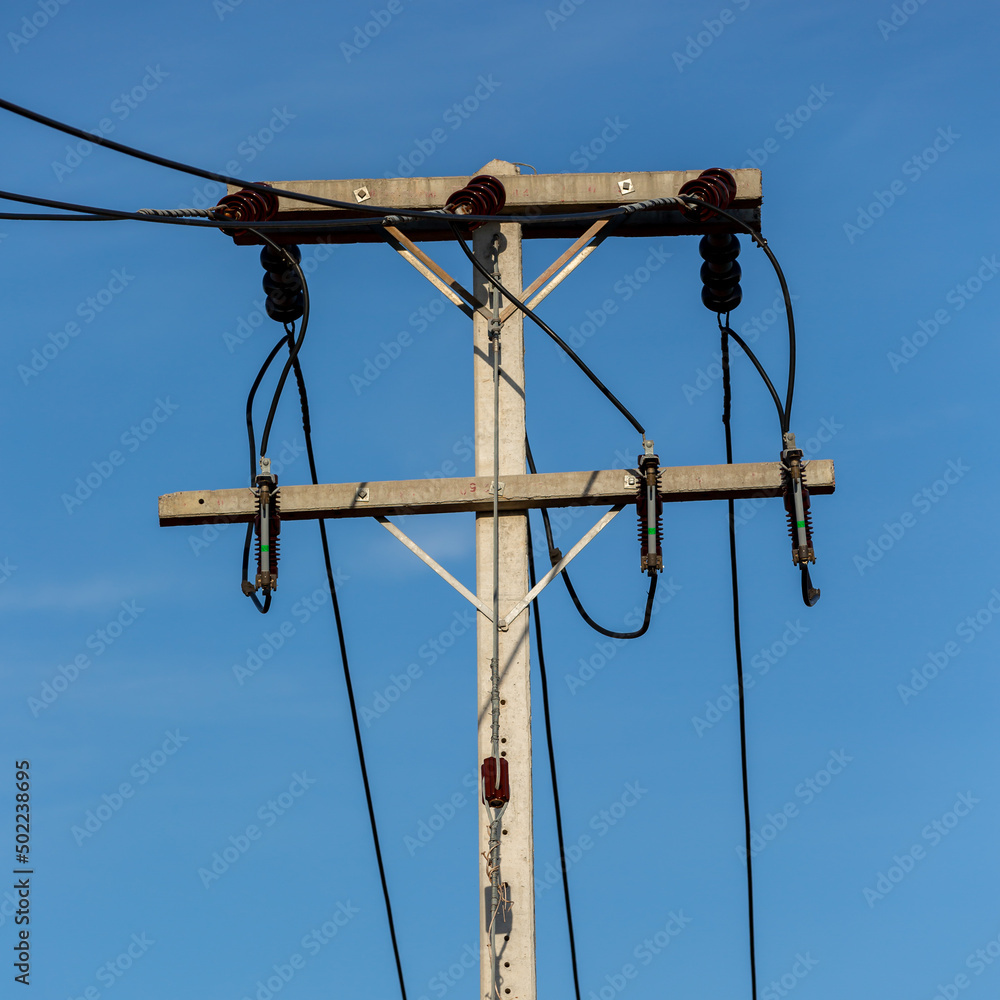 Electric Pole Power Lines And Wires With Blue Sky Background