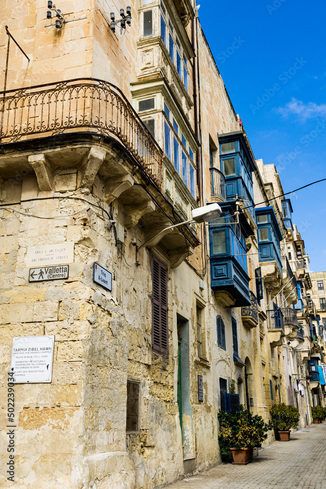 Typical Maltese street with balconies and blue windows