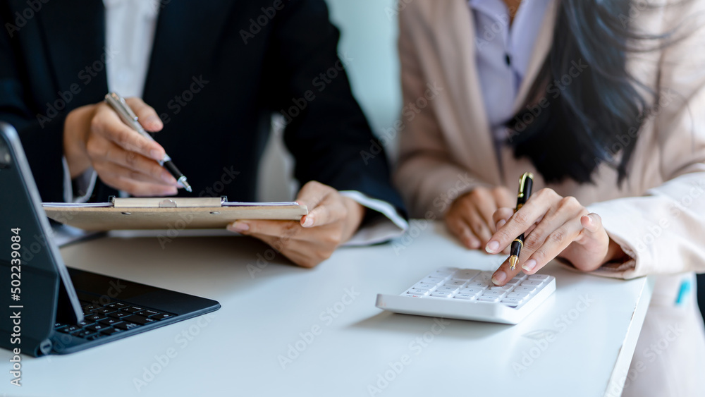 Business people discuss investment project working and planning strategy and using calculator during a business meeting. Business people discuss investment project working and planning strategy and using calculator during a business meeting.