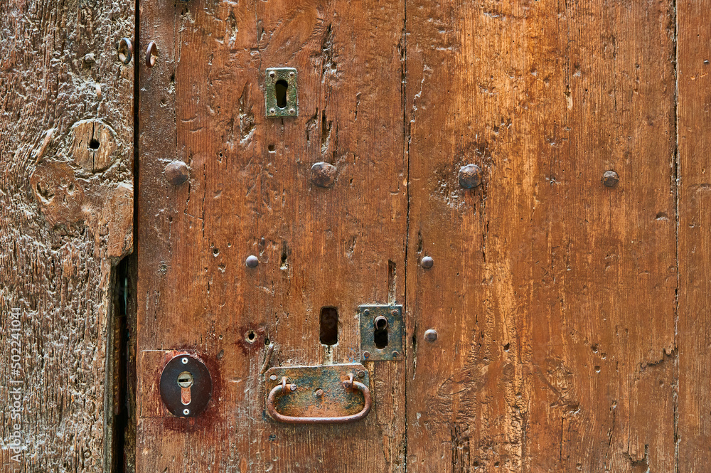 Detail of wooden ancient door with old iron rivets Detail of wooden ancient door with old iron rivets
