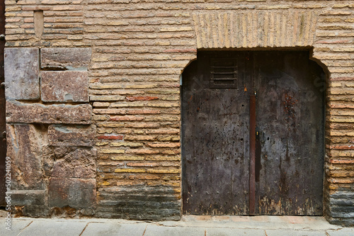 Detail of wooden ancient door with old iron rivets © Juanma