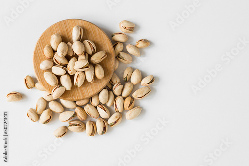 Pistachios isolated on white background, top view. Flat lay