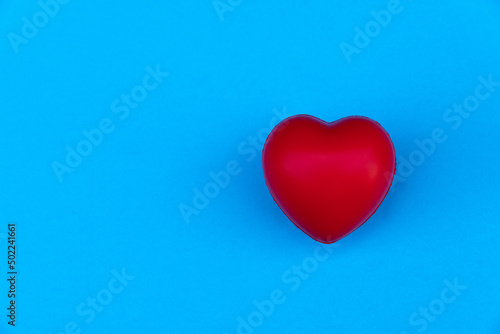 Red heart shape on a blue background.Top view. Copy space.MOCKUP Concept of love and health.