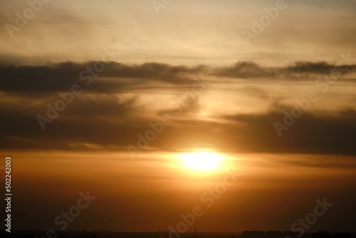 Fototapeta Naklejka Na Ścianę i Meble -  Evening dramatic sky with clouds during sunset. The sun sets behind dark clouds