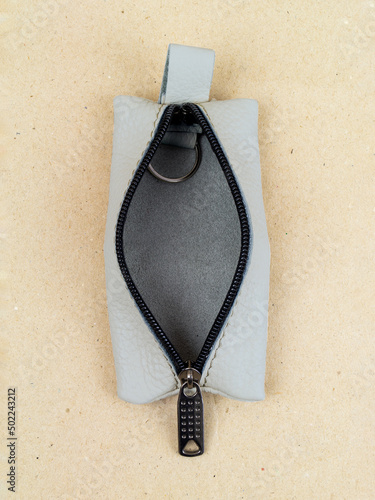 The housekeeper made of genuine leather lies on the table on paper