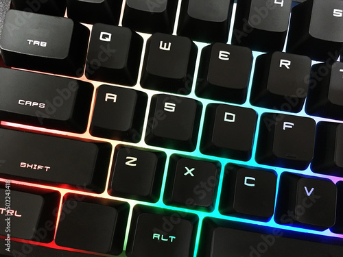 Modern gaming keyboard with bright backlit keys on the table