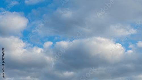 Blue sky background with clouds. White cumulus clouds in blue sky. Cloudy weather  cloudscape  copy space. Space for text.