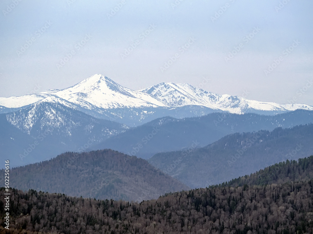 Panorama of mountain peaks covered with snow.