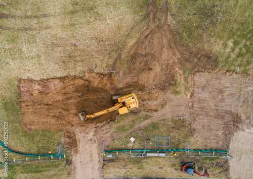 Construction site with digger levelling out ground for house build