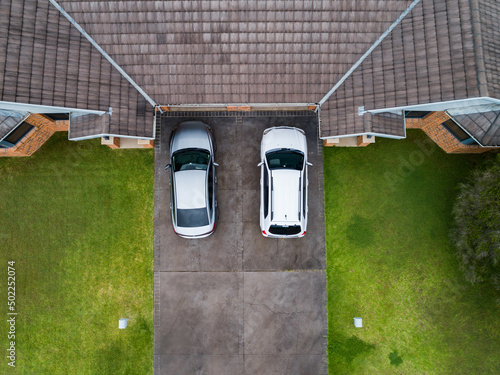 Cars parked in driveway of unit house photo