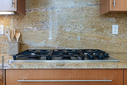 Konstfotografi Modern kitchen detail of sandy pattern granite counter and backsplash with grill