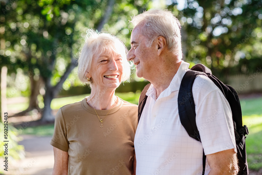 smiling senior couple on a walk smiling senior couple on a walk