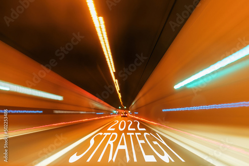 Text strategy 2022 on the road in the tunnel with a blurred light. New life concept. 