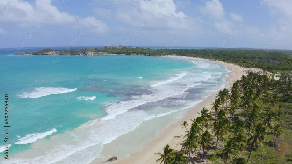 Sunny summer day on paradise sea palm beach of tropical peninsula. White sand and turquoise waves for outdoor activities. Beautiful seascape. Journey to a tropical paradise. Sunny summer day on paradise sea palm beach of tropical peninsula. White sand and turquoise waves for outdoor activities. Beautiful seascape. Journey to a tropical paradise.
