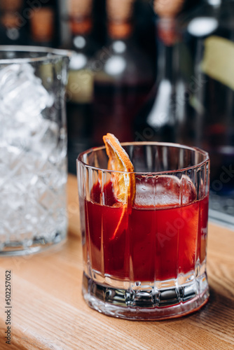 Homemade cocktail on Red Boulevard. glass martini with raspberry cocktail with raspberry alcohol and orange garnish.Cafe advertisement. Bar menu