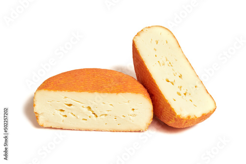 Piece of creamy red molded soft french cheese isolated on white background photo
