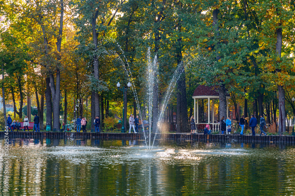 High fountain in the pond in the city recreation and entertainment park named after Maxim Gorky. Kharkiv city. Evening lighting. High fountain in the pond in the city recreation and entertainment park named after Maxim Gorky. Kharkiv city. Evening lighting.