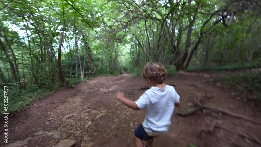 Child walking outside in nature little boy walks outdoors in green path Child walking outside in nature little boy walks outdoors in green path