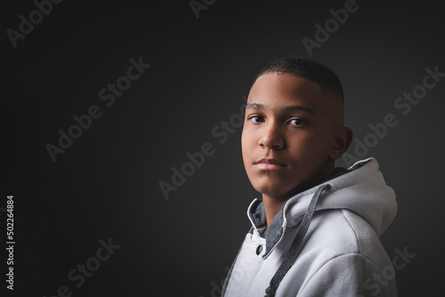 Obraz na plátně Portrait of very serious African-American teenager on a black background